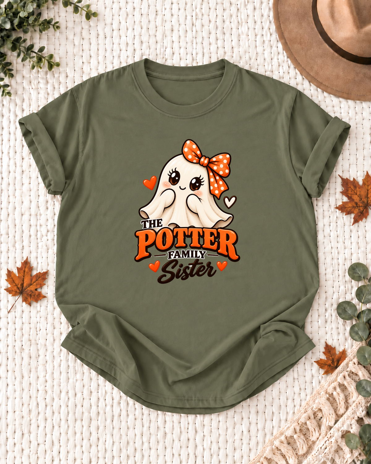 Sister's Olive personalized Halloween shirt mockup with a smiling ghost with an orange bow and heart accents, sample family lettering, and the role label.