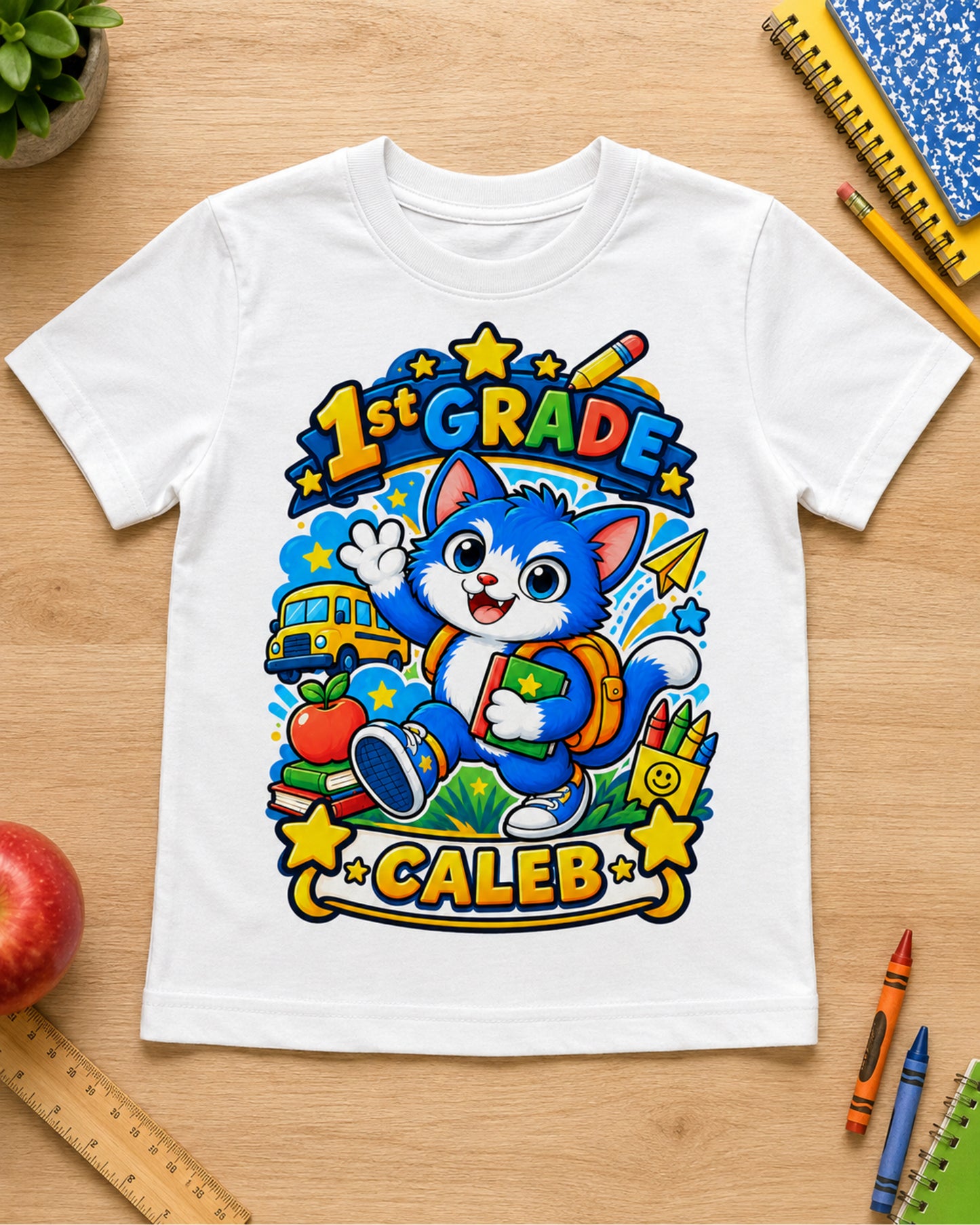 White personalized first grade cat youth shirt flat lay with the example name Caleb.