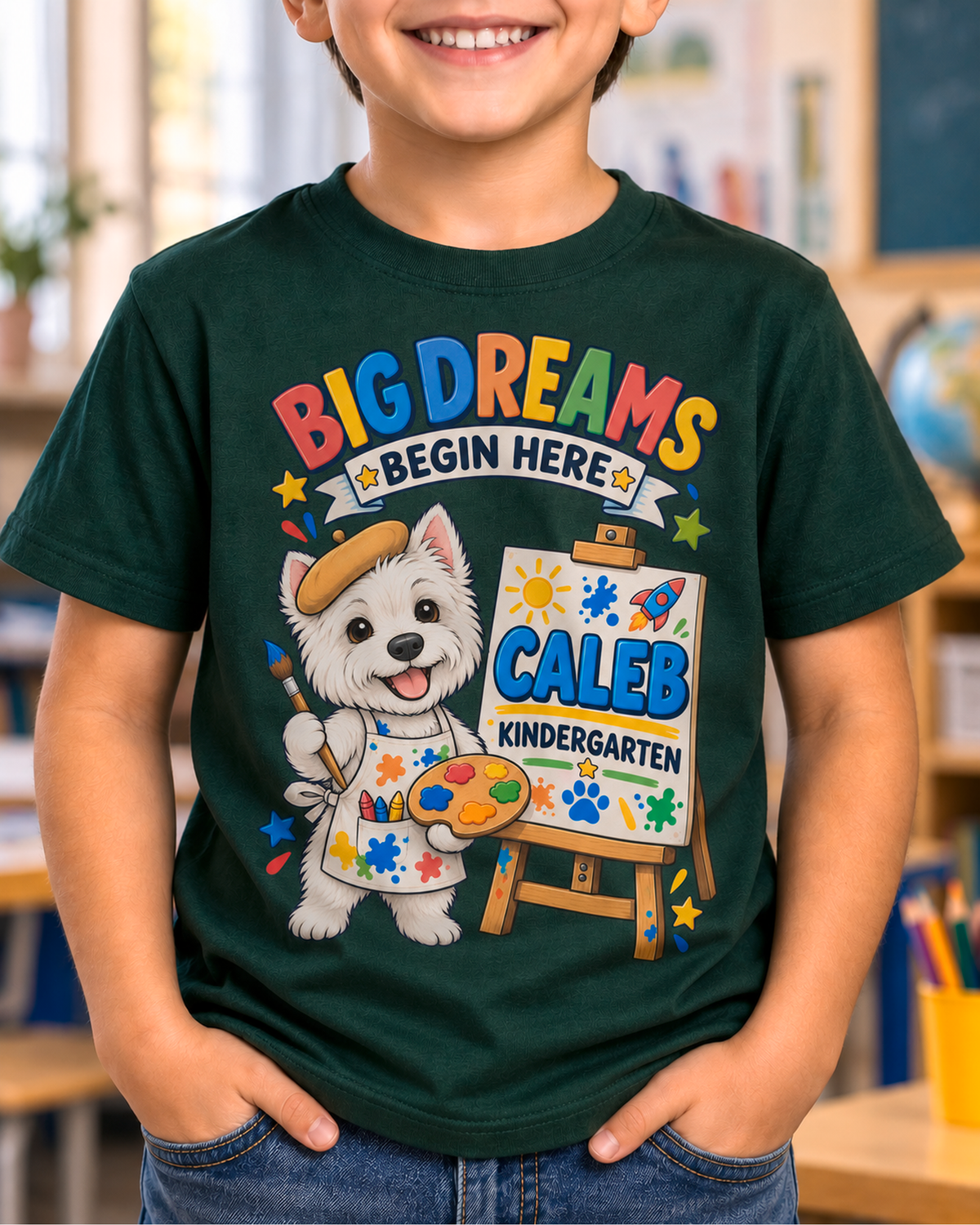 Child wearing a forest green personalized kindergarten artist dog shirt with the sample name Caleb in a classroom.