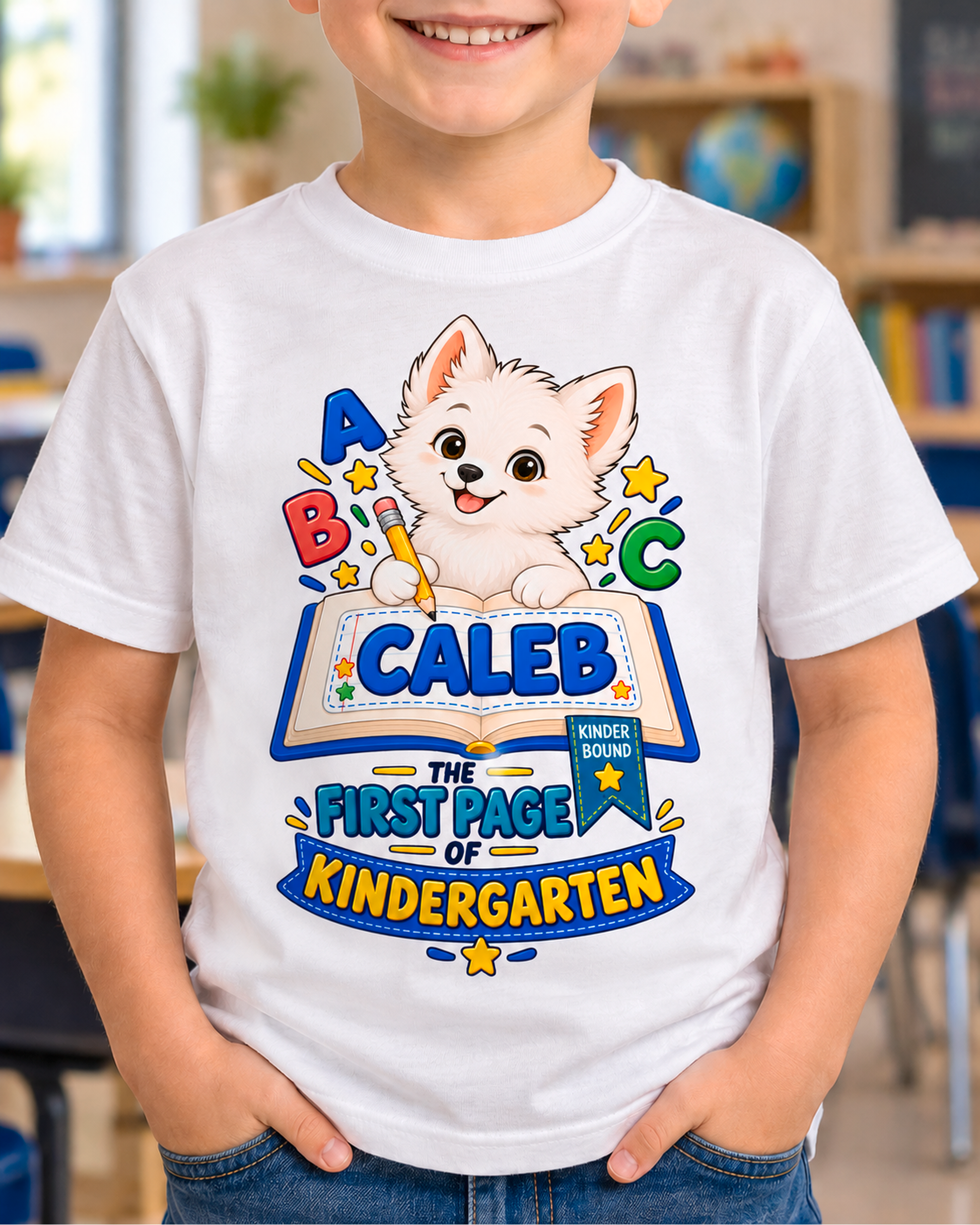 Child wearing a white personalized kindergarten ABC dog shirt with the sample name Caleb in a classroom.