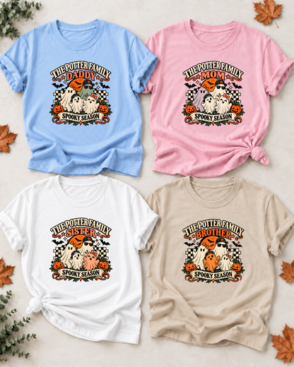 Four Halloween family T-shirts with friendly ghosts: Daddy in light blue, Mom in light pink, Sister in white, and Brother in sand, each showing example family-name text and Spooky Season lettering.