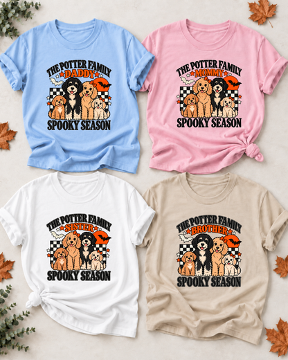 Four Halloween family T-shirts with illustrated dogs: Daddy in light blue, Mommy in light pink, Sister in white, and Brother in sand, each showing example family-name text and Spooky Season lettering.