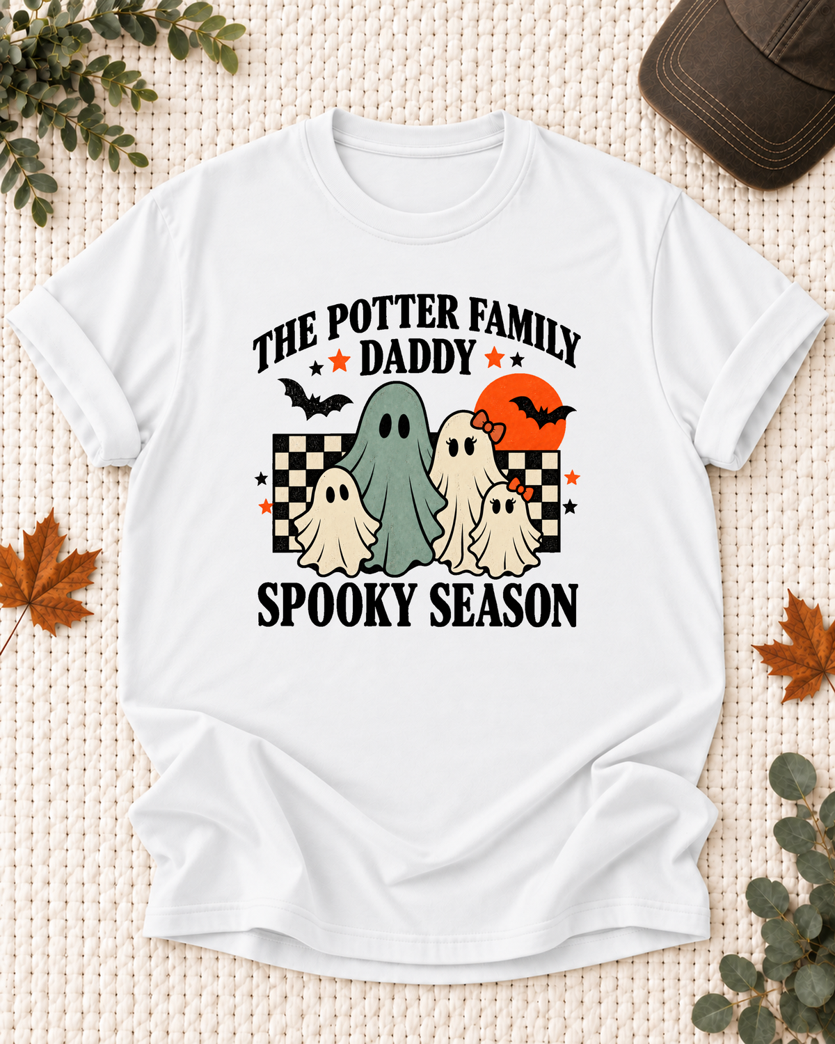 White Daddy T-shirt with friendly ghosts, an orange moon, bats, black-and-cream checkerboard accents, and example family-name text.