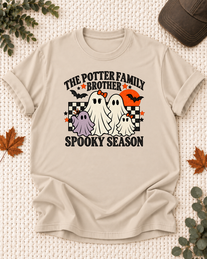 Sand Brother T-shirt with friendly ghosts, an orange moon, bats, black-and-cream checkerboard accents, and example family-name text.