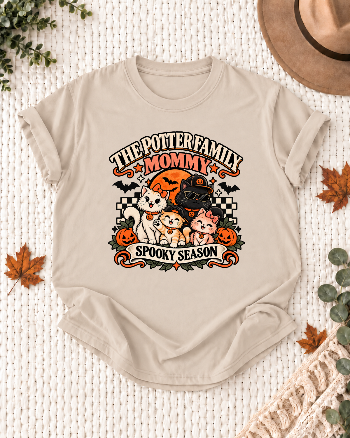 Sand Mommy T-shirt with costume-inspired cats, including a black cat in a pumpkin cap and sunglasses, with example family-name text.