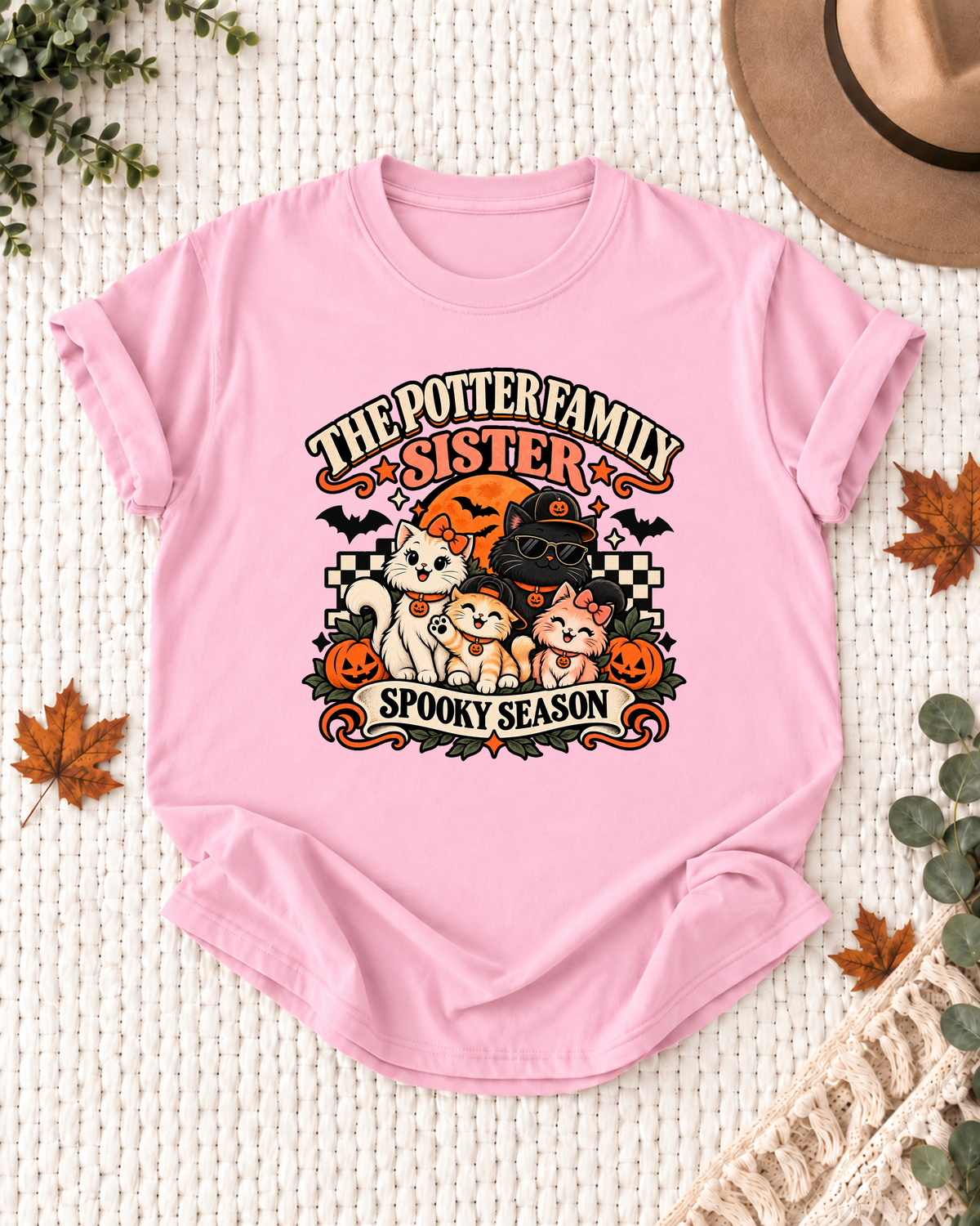 Light pink Sister T-shirt with costume-inspired cats, including a black cat in a pumpkin cap and sunglasses, with example family-name text.