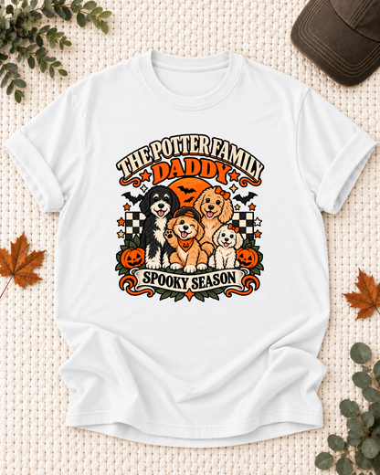 White Daddy T-shirt with four dogs, including a puppy in a backward cap and pumpkin bandana, with jack-o'-lanterns and the example name "The Potter Family."