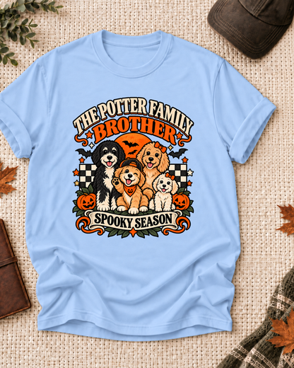 Light blue Brother T-shirt with orange role lettering, four dogs, jack-o'-lanterns, and "Spooky Season" text, showing the example name "The Potter Family."