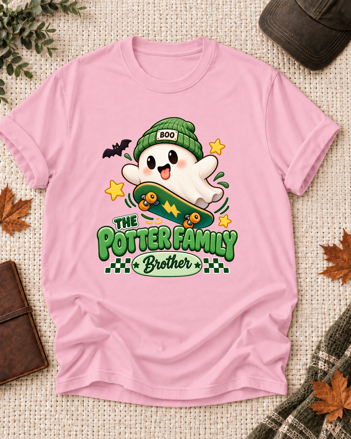 Brother's Light Pink personalized Halloween shirt mockup with a ghost in a green beanie with a skateboard and bat, sample family lettering, and the role label.