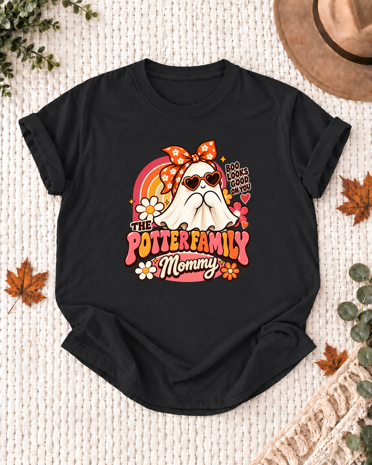 Mommy's Black personalized Halloween shirt mockup with a ghost with an orange bow, heart glasses, and rainbow, sample family lettering, and the role label.