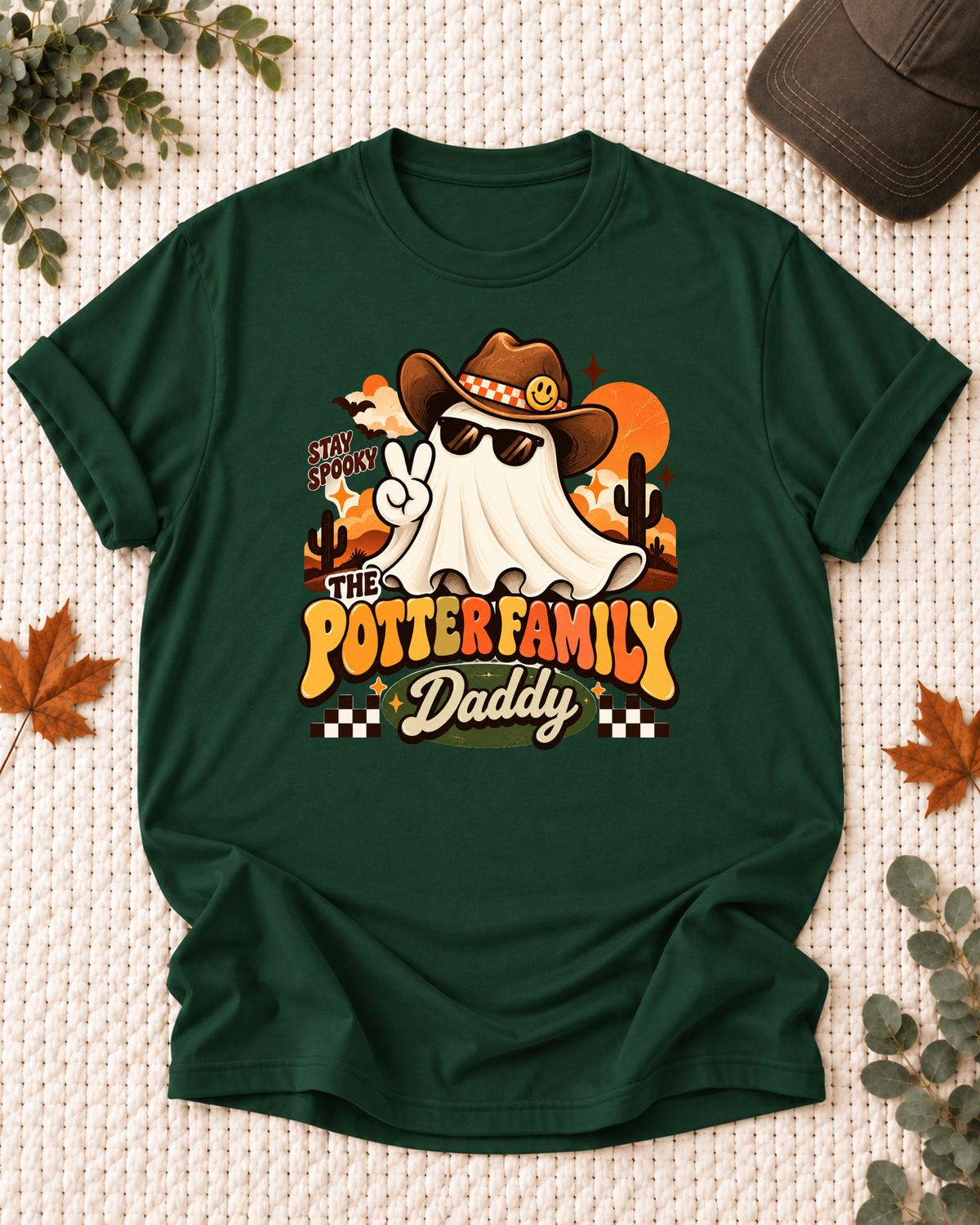 Daddy's Dark Green personalized Halloween shirt mockup with a ghost in a cowboy hat and sunglasses with desert accents, sample family lettering, and the role label.
