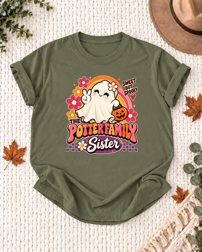 Sister's Olive personalized Halloween shirt mockup with a ghost with flowers, candy accents, and a pumpkin bag, sample family lettering, and the role label.