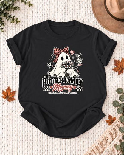 Mommy's Black personalized Halloween shirt mockup with a line-art ghost with a patterned bow and floral accents, sample family lettering, and the role label.