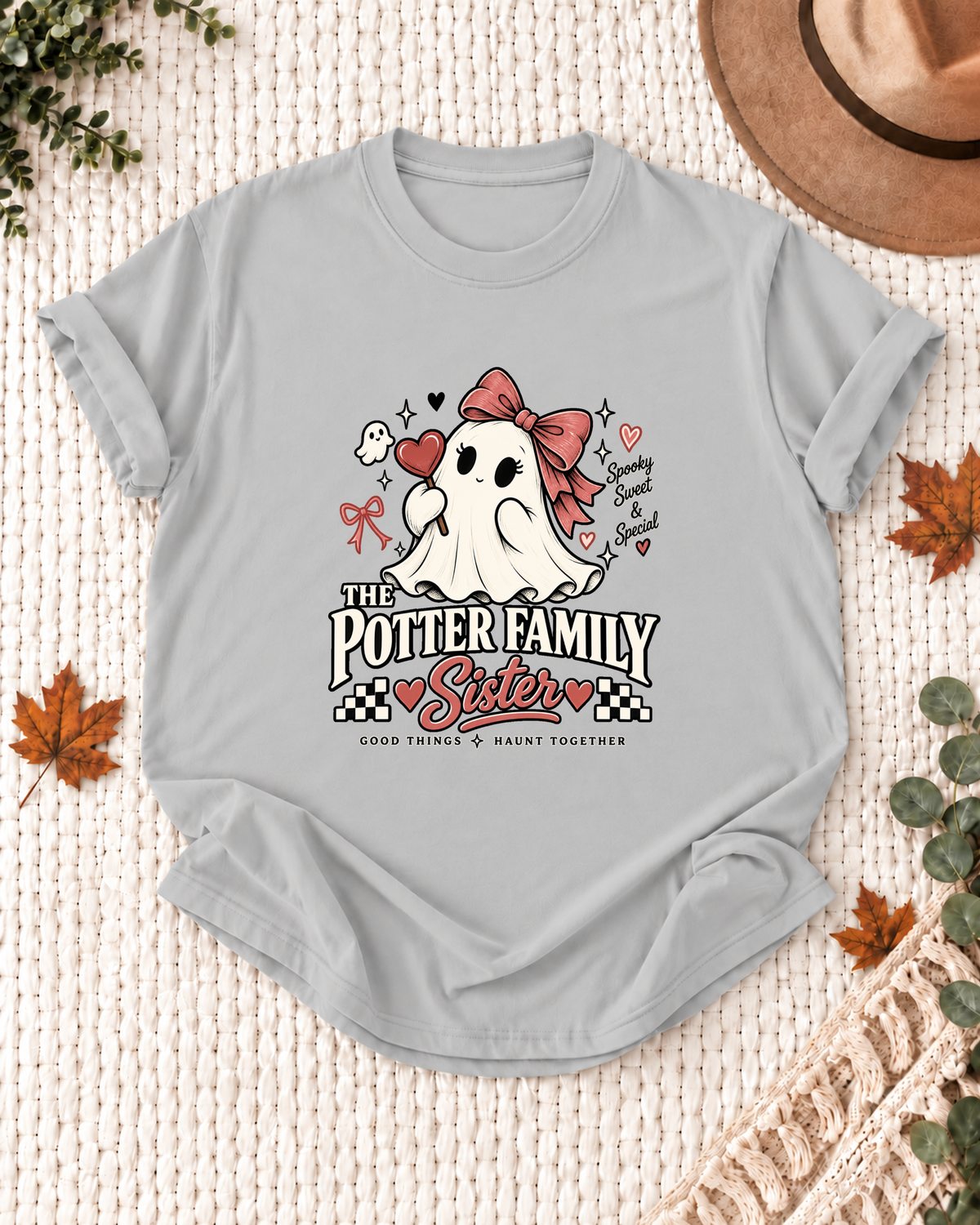 Sister's Ash Grey personalized Halloween shirt mockup with a line-art ghost with a bow, hearts, and small ghost accents, sample family lettering, and the role label.