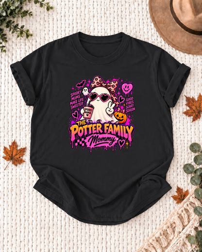 Mommy's Black personalized Halloween shirt mockup with a ghost with a bow, heart glasses, and pumpkin, sample family lettering, and the role label.