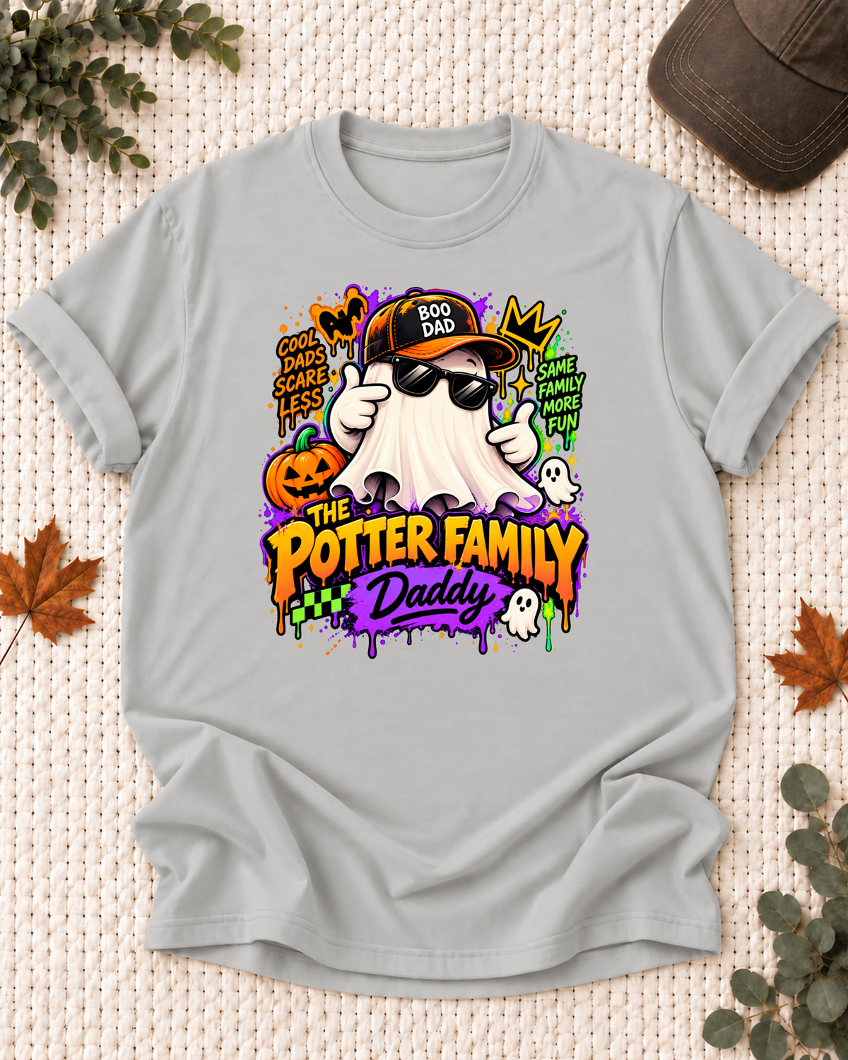 Daddy's Ash Grey personalized Halloween shirt mockup with a ghost in a cap and sunglasses with neon accents, sample family lettering, and the role label.