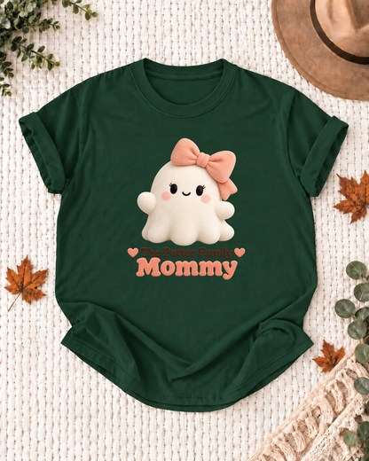 Mommy's Dark Green personalized Halloween shirt mockup with a soft rounded ghost with a peach bow, sample family lettering, and the role label.