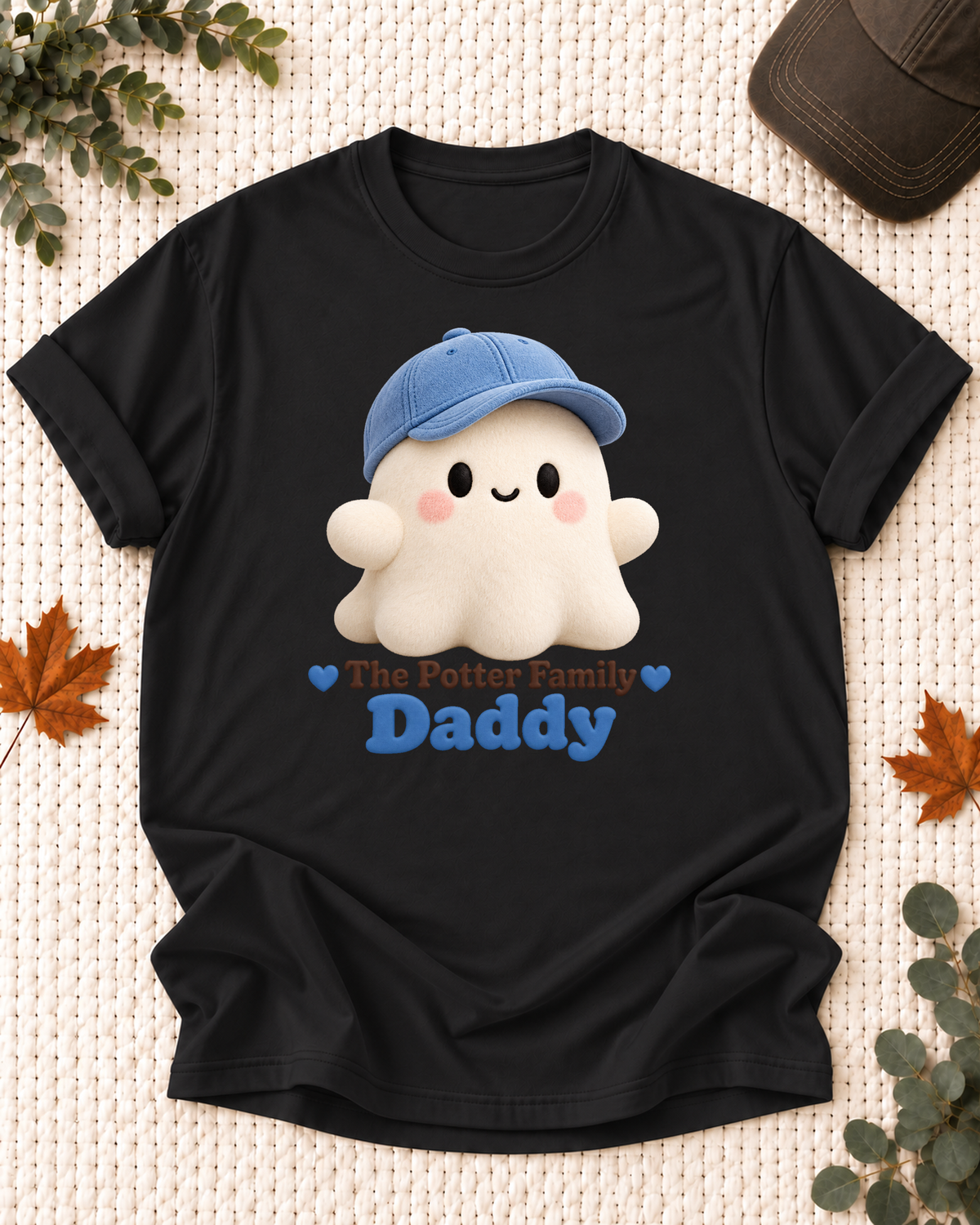 Daddy's Black personalized Halloween shirt mockup with a soft rounded ghost with a blue cap, sample family lettering, and the role label.