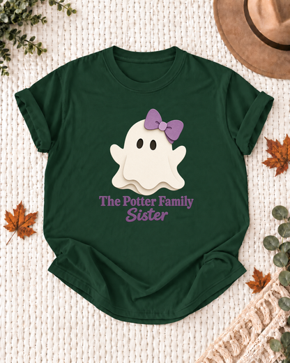 Sister's Dark Green personalized Halloween shirt mockup with a minimal cream ghost with a purple bow, sample family lettering, and the role label.