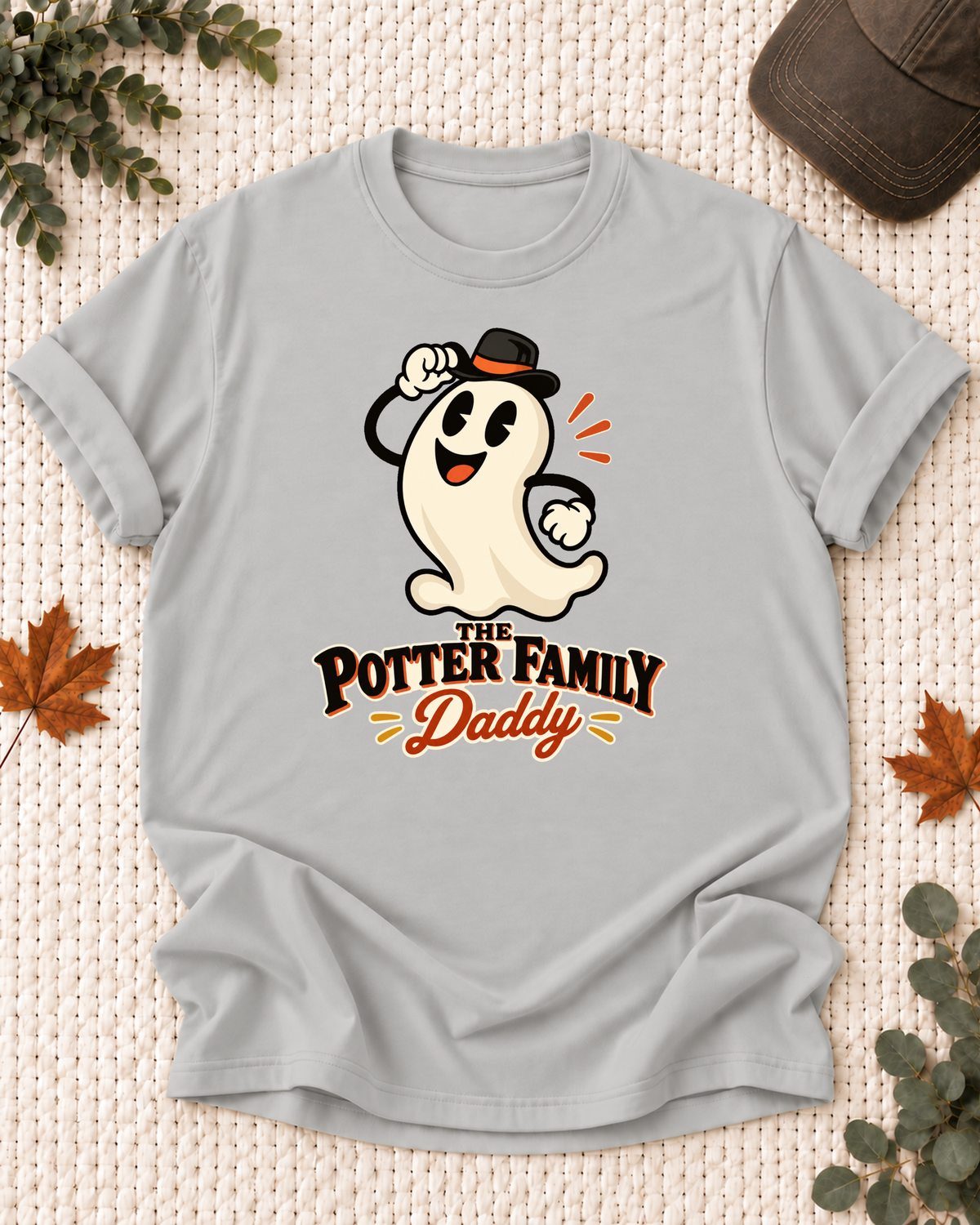Daddy's Ash Grey personalized Halloween shirt mockup with a cartoon ghost in a black hat with orange accent, sample family lettering, and the role label.