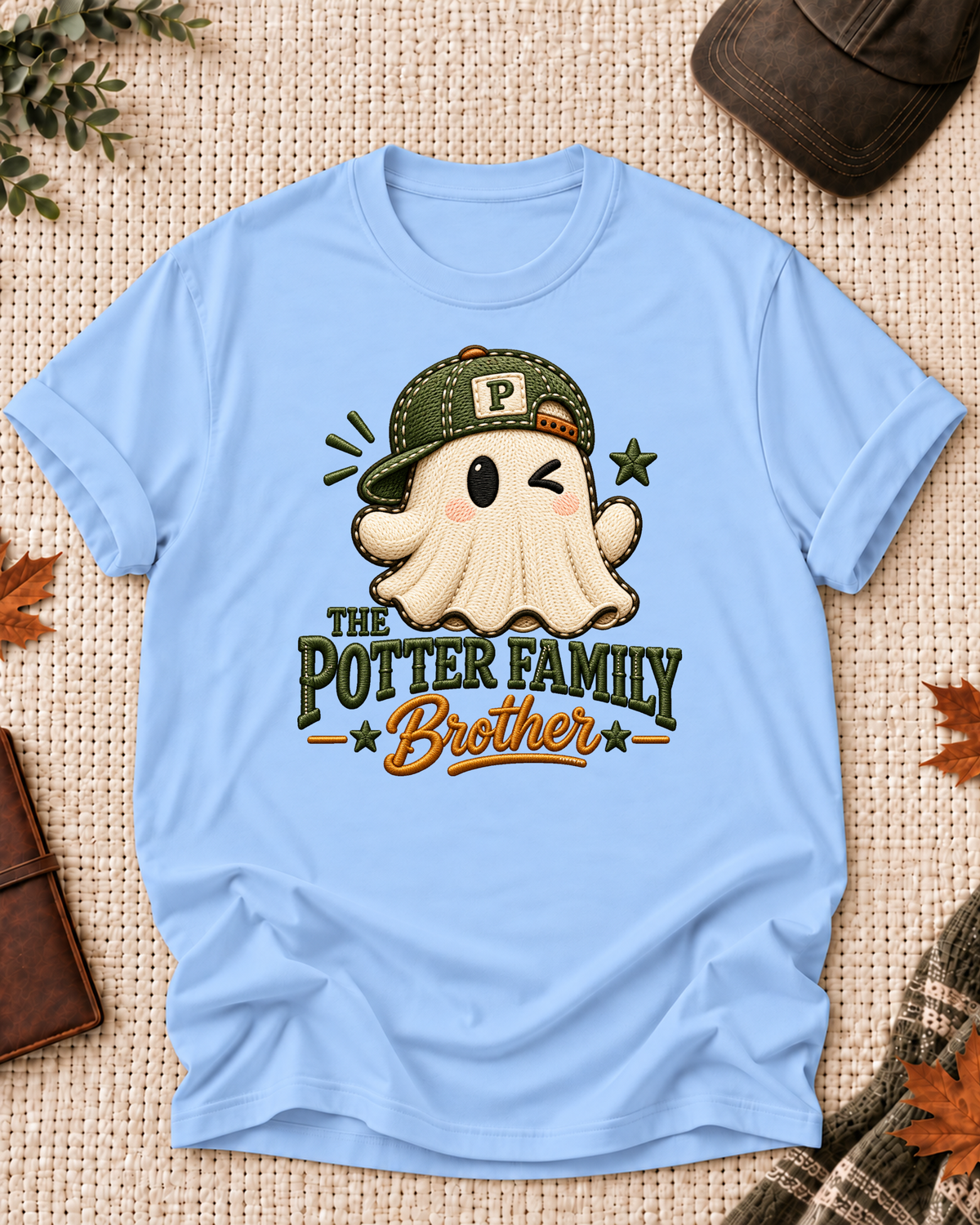 Brother's Light Blue personalized Halloween shirt mockup with a stitched-look ghost with an olive cap and star accents, sample family lettering, and the role label.