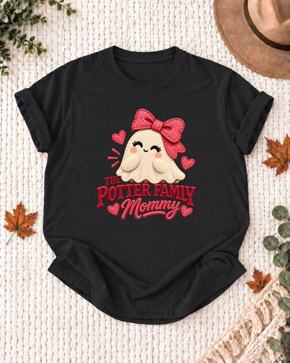 Mommy's Black personalized Halloween shirt mockup with a patchwork-style ghost with a red bow and heart patches, sample family lettering, and the role label.