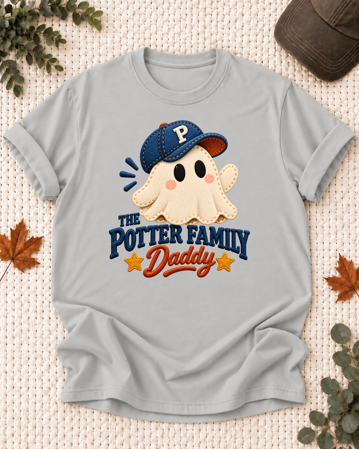 Daddy's Ash Grey personalized Halloween shirt mockup with a patchwork-style ghost with a navy cap and mustard stars, sample family lettering, and the role label.
