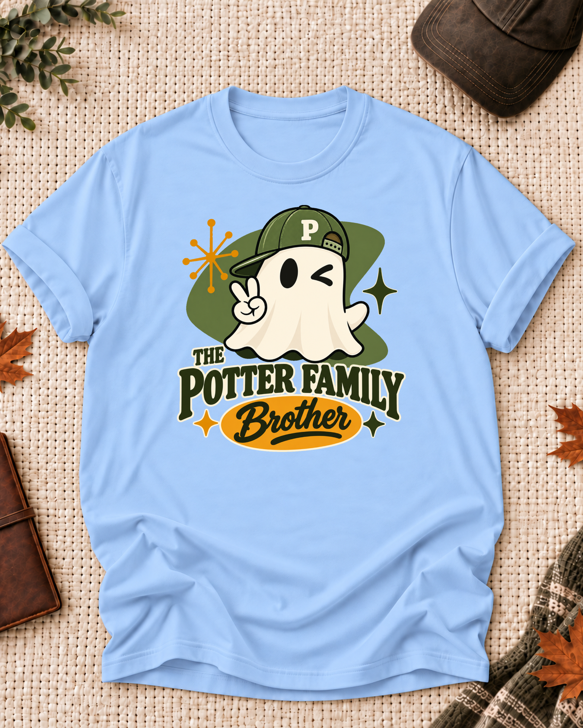 Brother's Light Blue personalized Halloween shirt mockup with a mid-century ghost with an olive cap, green field, and starbursts, sample family lettering, and the role label.