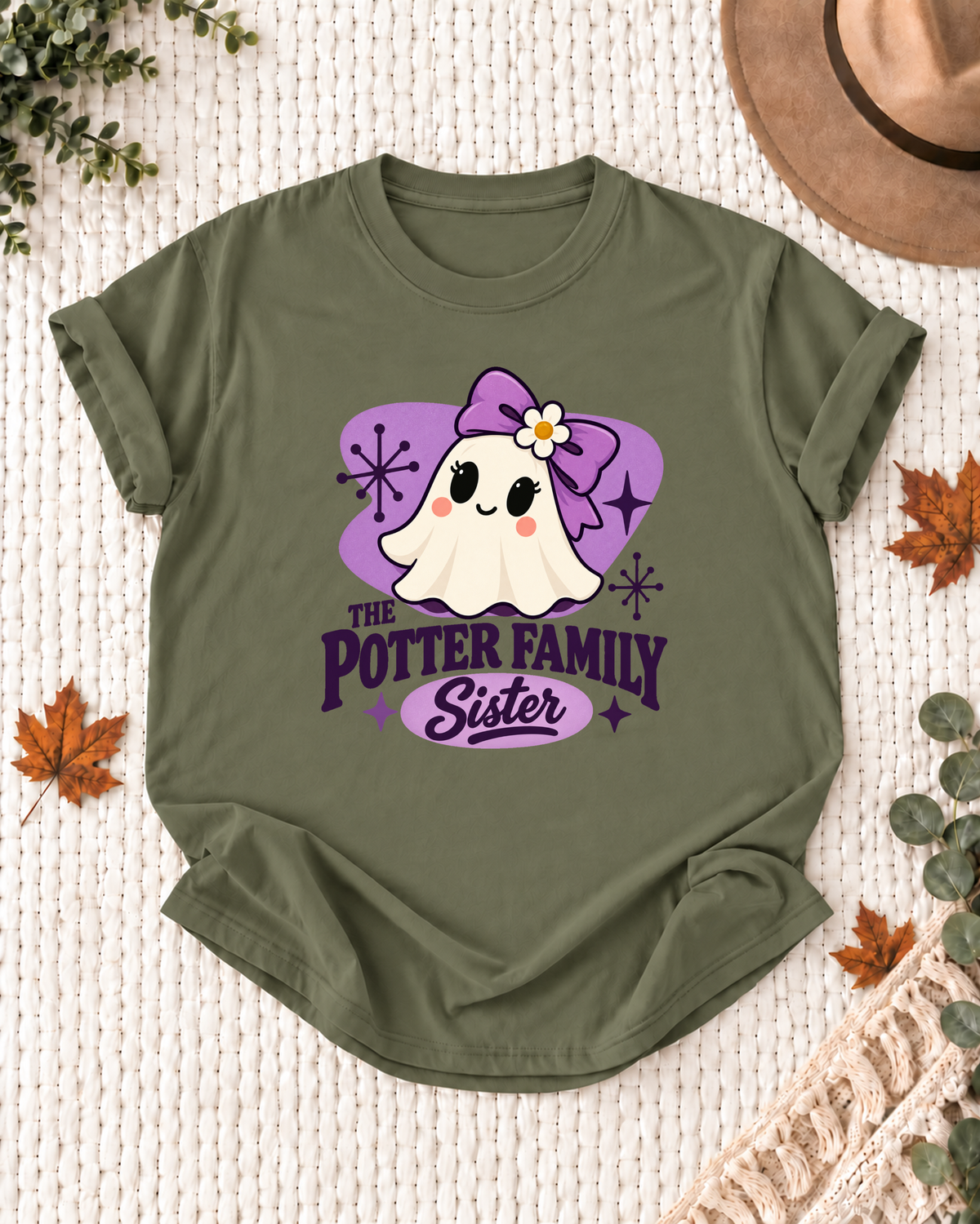 Sister's Olive personalized Halloween shirt mockup with a mid-century ghost with a purple bow, purple field, and starbursts, sample family lettering, and the role label.