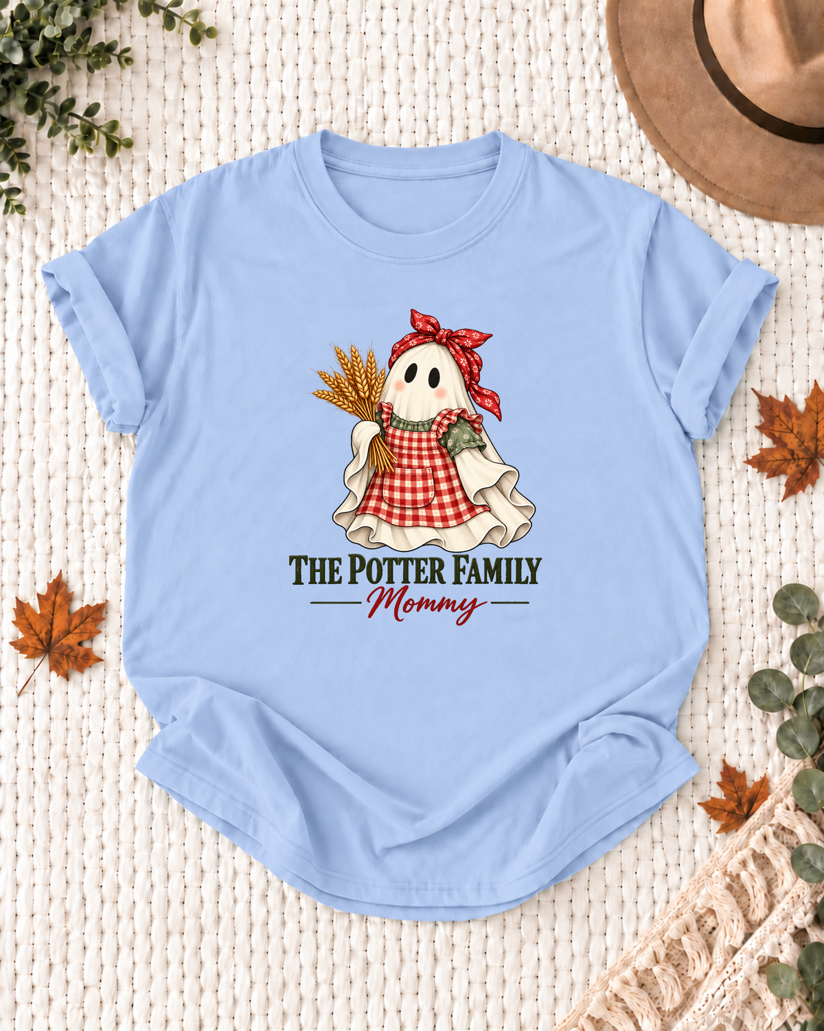 Mommy's Light Blue personalized Halloween shirt mockup with a farm ghost with harvest and sunflower details, sample family lettering, and the role label.