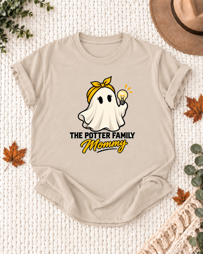 Mommy's Sand personalized Halloween shirt mockup with an electrician ghost with a bulb and tool details, sample family lettering, and the role label.
