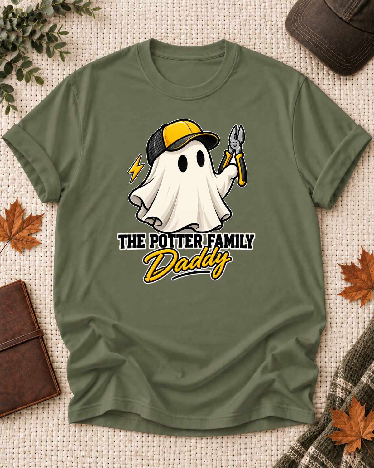 Daddy's Olive personalized Halloween shirt mockup with an electrician ghost with pliers and electrical accents, sample family lettering, and the role label.