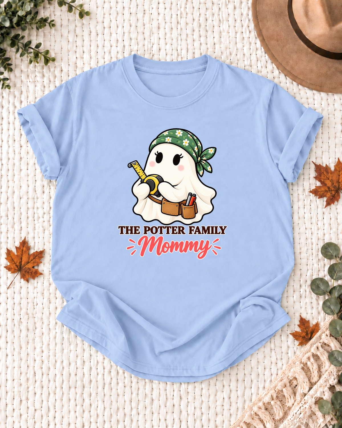 Mommy's Light Blue personalized Halloween shirt mockup with a carpenter ghost with measuring tools, sample family lettering, and the role label.