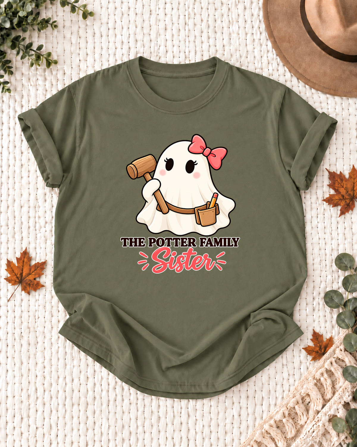 Sister's Olive personalized Halloween shirt mockup with a carpenter ghost with a mallet and measuring details, sample family lettering, and the role label.