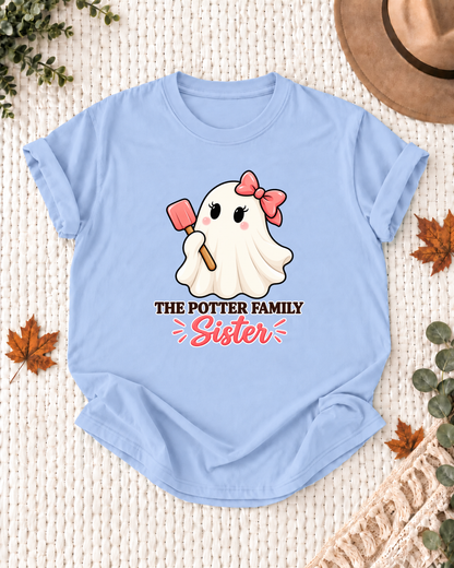 Sister's Light Blue personalized Halloween shirt mockup with a baking ghost with a spatula and chef-hat details, sample family lettering, and the role label.