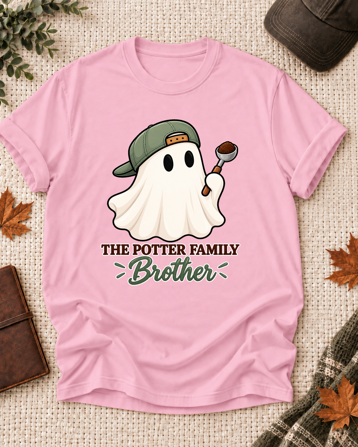 Brother's Light Pink personalized Halloween shirt mockup with a coffee ghost with coffee grounds and spoon accents, sample family lettering, and the role label.