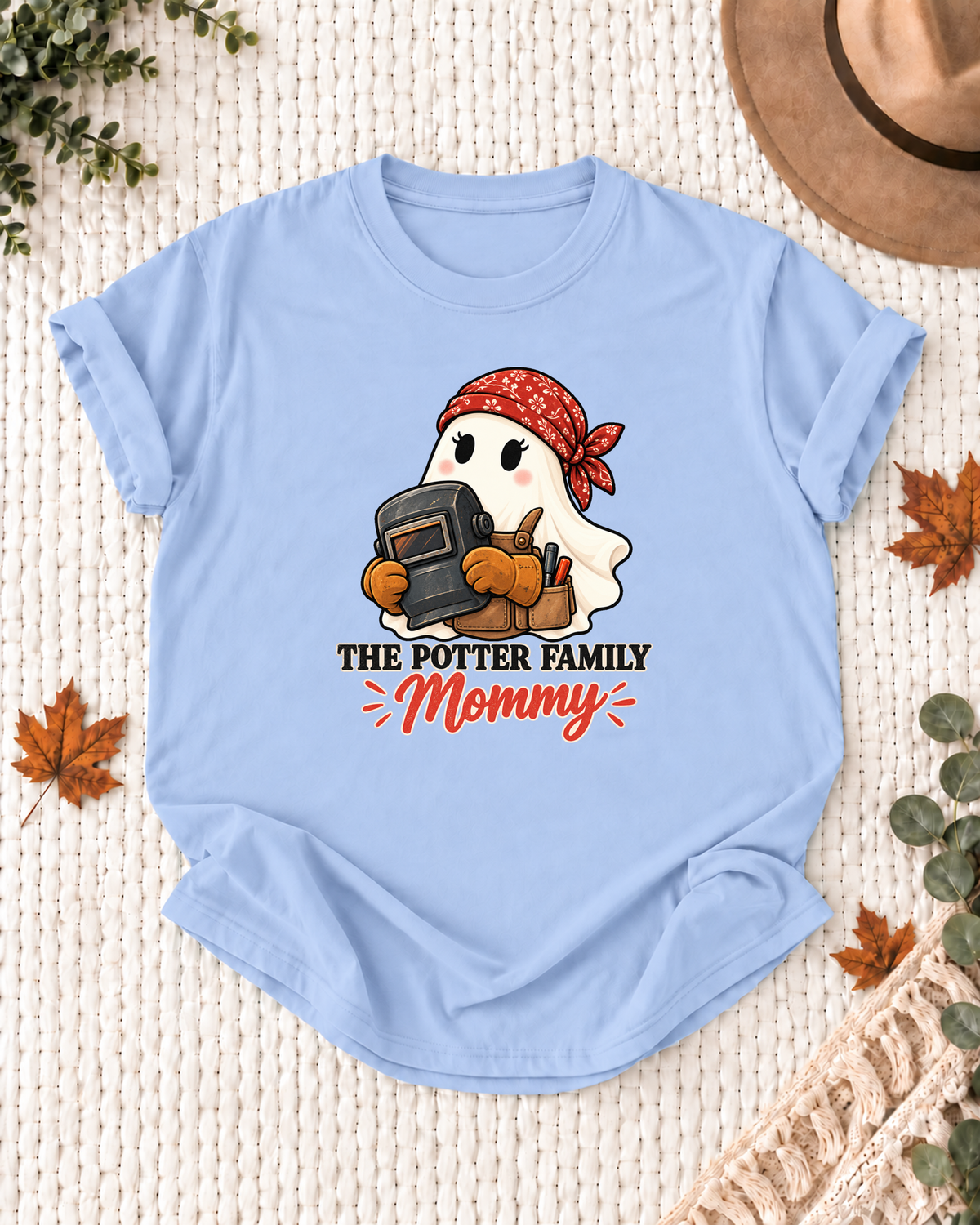 Mommy's Light Blue personalized Halloween shirt mockup with a welder ghost with protective helmet details, sample family lettering, and the role label.