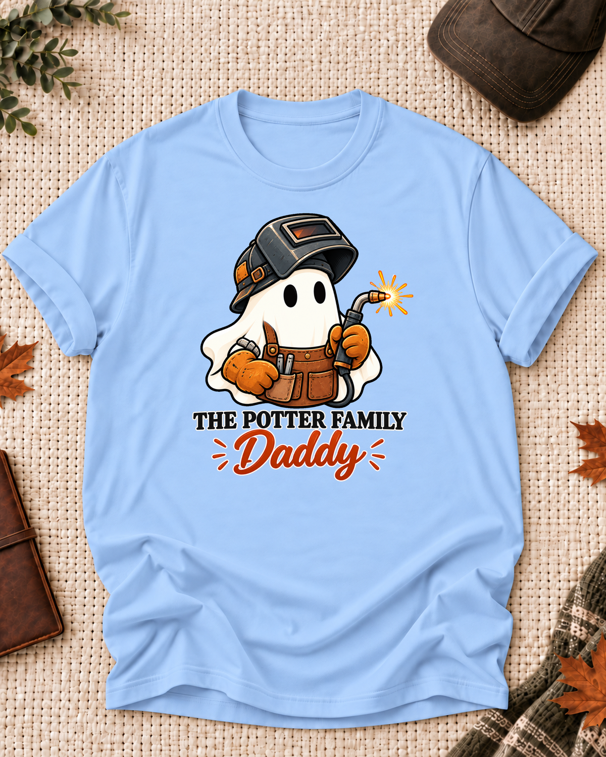 Daddy's Light Blue personalized Halloween shirt mockup with a welder ghost with a welding torch and spark, sample family lettering, and the role label.