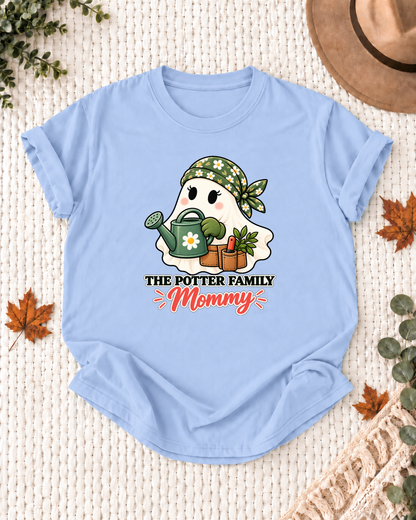 Mommy's Light Blue personalized Halloween shirt mockup with a garden ghost with a watering can and plant details, sample family lettering, and the role label.