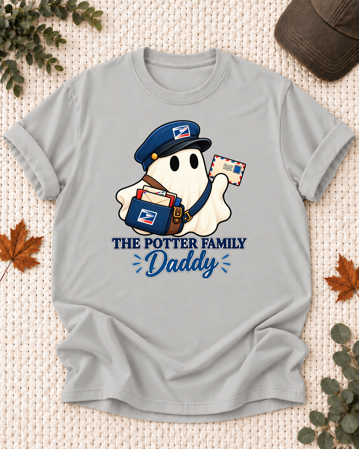 Daddy's Ash Grey personalized Halloween shirt mockup with a mail carrier ghost with a delivery bag, sample family lettering, and the role label.