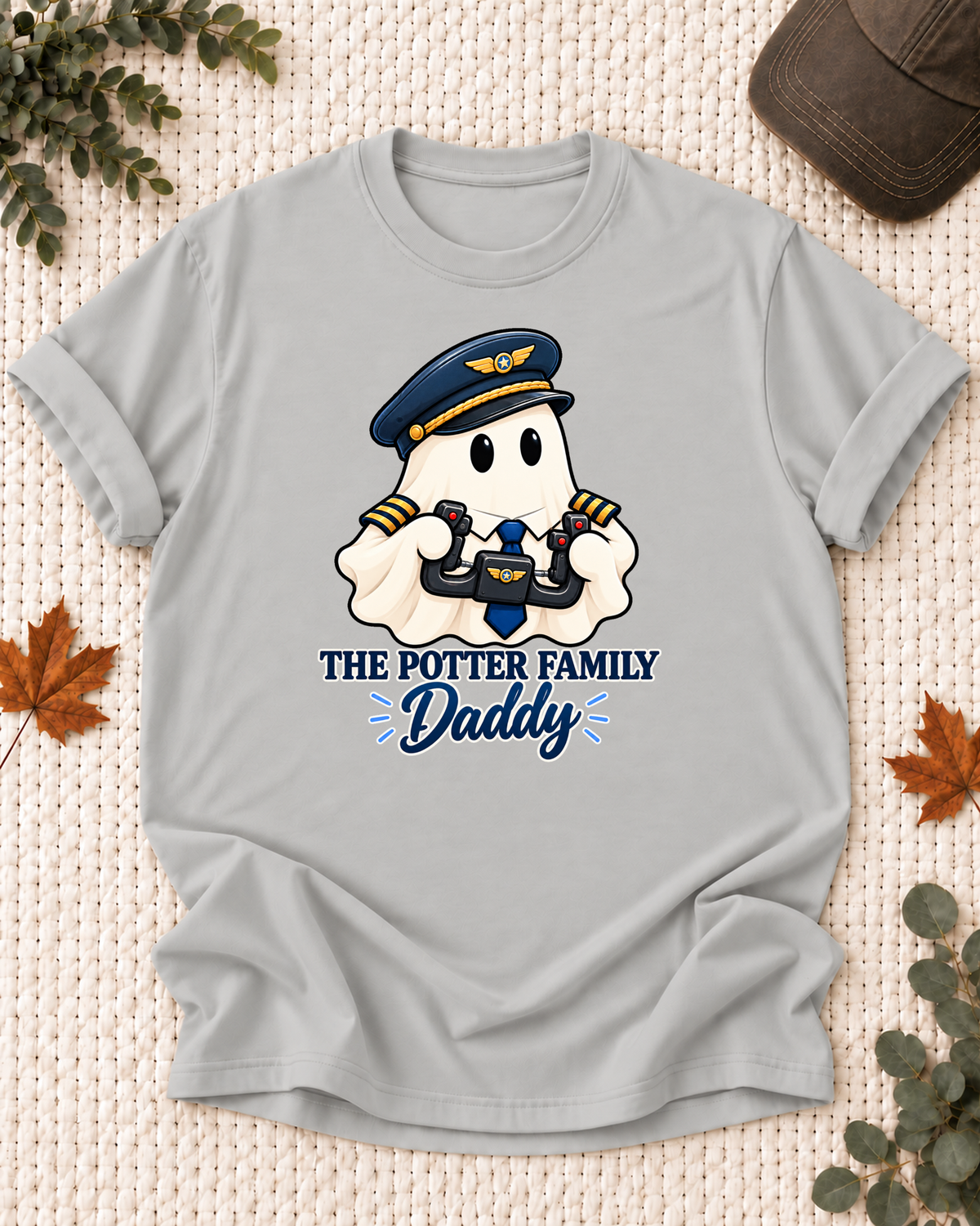 Daddy's Ash Grey personalized Halloween shirt mockup with a pilot ghost with a pilot cap and control yoke, sample family lettering, and the role label.