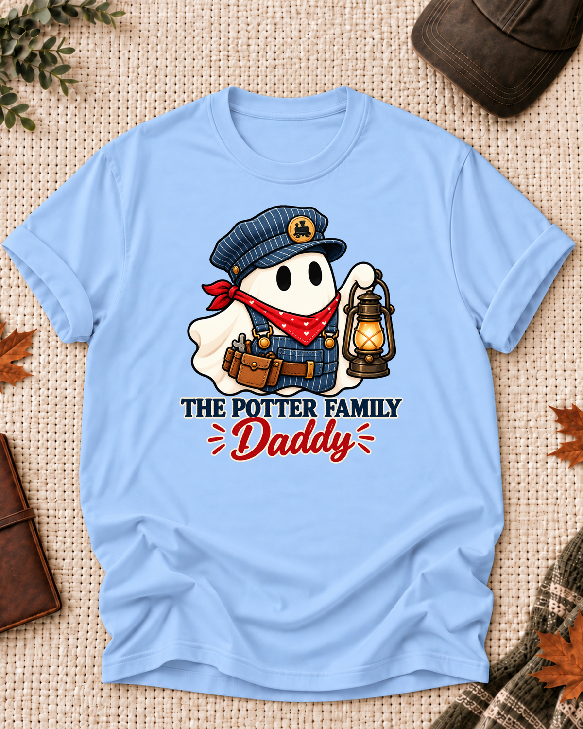 Daddy's Light Blue personalized Halloween shirt mockup with a train conductor ghost with bandana and lantern, sample family lettering, and the role label.