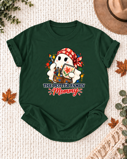 Mommy's Dark Green personalized Halloween shirt mockup with an artist ghost with palette and brush details, sample family lettering, and the role label.